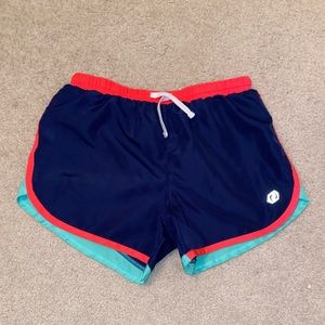 Navy, green, and pink athletic shorts.